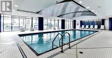 Toronto (Willowdale West) condo for rent - A large indoor swimming pool with a glass wall and a skylight.