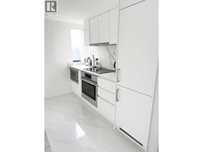 Vancouver apartment for rent - A white kitchen with a sink and a window.