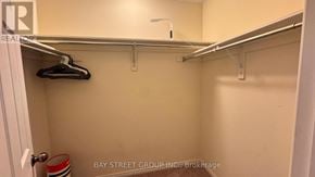 Niagara Falls (Brown) apartment for rent - A small closet with a coat hanging on a rod.