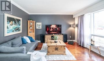 Toronto (Kennedy Park) apartment for rent - A living room with a grey couch, a wooden coffee table, and a painting on the wall.