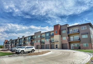 Hickman apartment for rent - A modern apartment complex with a car parked in front.