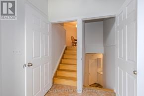 Ottawa apartment for rent - A white doorway opens to a hallway with a staircase.
