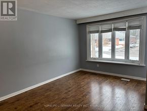 Ajax (South East) apartment for rent - A kitchen with a white fridge and wooden cabinets.