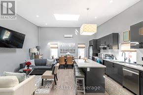Niagara Falls (Dorchester) apartment for rent - A modern kitchen and living room with a dining area in the middle.