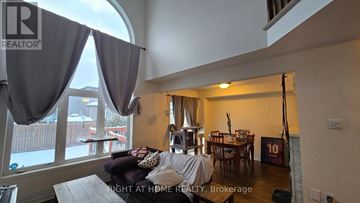 Ottawa townhouse for rent - A living room with a couch and a dining table.