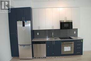 Hamilton (Kirkendall) condo for rent - A kitchen with dark blue cabinets and stainless steel appliances.