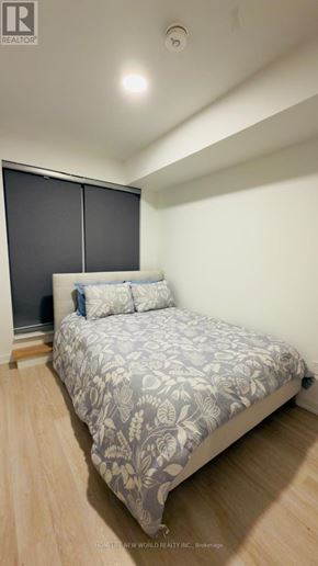 Hamilton (Kirkendall) condo for rent - A bedroom with a bed and a wooden floor.