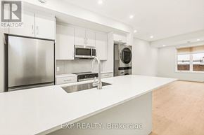 Ottawa multi-family for rent - A modern kitchen with white countertops and stainless steel appliances.