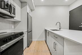 Ottawa multi-family for rent - A modern kitchen with white cabinets and stainless steel appliances.