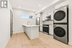 Ottawa multi-family for rent - A kitchen with a sink, oven, and microwave.