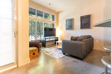 Charlotte apartment for rent - A living room with a grey couch and a flat screen TV.