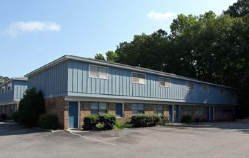 Summerville apartment for rent - A blue building with a parking lot in front.
