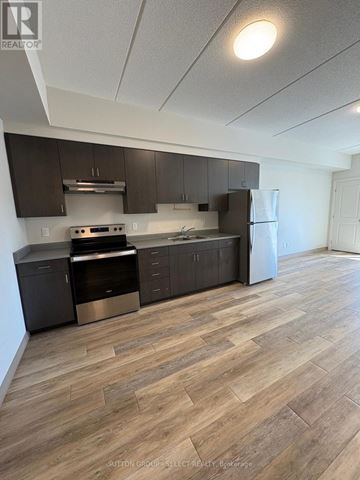 London South (South J) condo for rent - A kitchen with wood flooring and modern appliances.