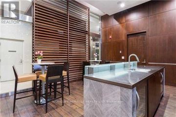 Mississauga (City Centre) condo for rent - A modern kitchen with a marble countertop and wooden flooring.