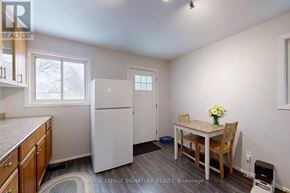 Toronto (North Riverdale) apartment for rent - A kitchen with a refrigerator, table and chairs.