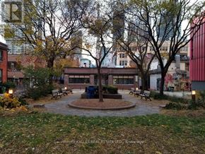 Toronto (Kensington-Chinatown) townhouse for rent - A park with a fountain surrounded by benches and trees.