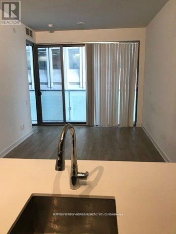 Toronto (Bay Street Corridor) condo for rent - A modern kitchen with a sink and a window with blinds.