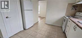 Kitchener apartment for rent - A kitchen with white appliances and cabinets.