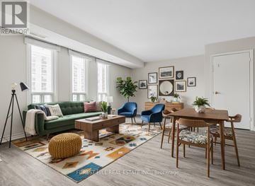 Toronto (Rexdale-Kipling) townhouse for rent - A living room with a green couch, a coffee table, and a rug with a pattern.