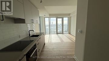 Toronto (Banbury-Don Mills) condo for rent - A kitchen with a view of the city through the windows.