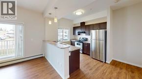 Grande Prairie apartment for rent - A kitchen with a refrigerator, stove, and oven.
