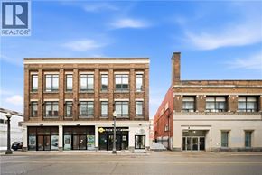 Brantford apartment for rent - A street view of a building with a REALTOR® sign.