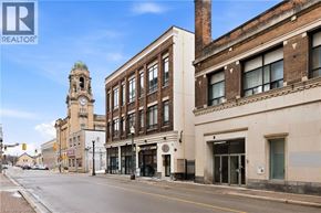 Brantford apartment for rent - A street view of a city with a clock tower in the background.
