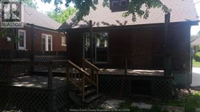 Windsor apartment for rent - A house with a porch and a sign that says REALTOR.