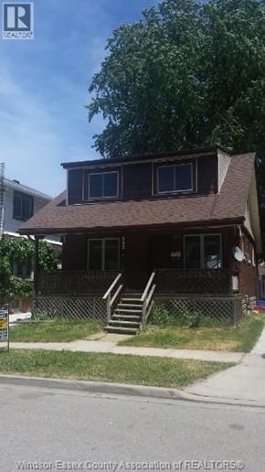 Windsor apartment for rent - A house with a brown roof and a fence in front of it.