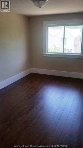 Windsor apartment for rent - A room with a window and wooden flooring.