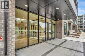 Waterloo condo for rent - The image shows the front of a building with the number 107 on it and a glass door entrance.