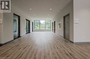 Waterloo condo for rent - A long hallway with wood floors and doors on both sides.
