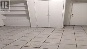 Toronto (West Hill) apartment for rent - A white tiled room with a white door and a white shelf.