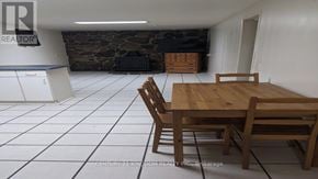 Toronto (West Hill) apartment for rent - A dining room with a wooden table and chairs.