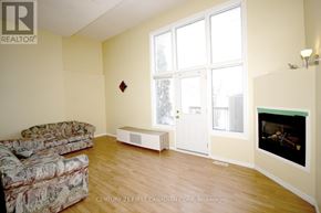 London North (North I) townhouse for rent - A living room with a couch, a fireplace, and a television.