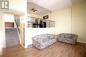 London North (North I) townhouse for rent - A living room with a couch and a cushioned chair.