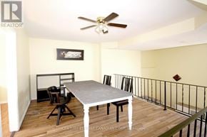London North (North I) townhouse for rent - A room with a table and chairs and a fan.
