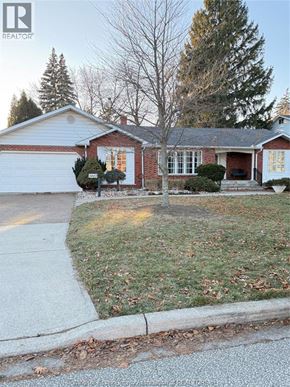 Windsor apartment for rent - A house with a red brick exterior and a white garage door.