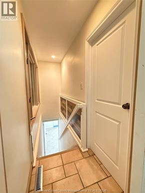Windsor apartment for rent - A hallway with a white door and a window.