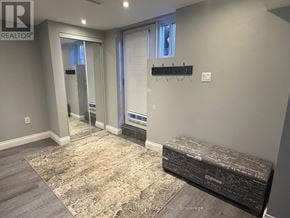 King (Nobleton) apartment for rent - A bedroom with a bed, a bench, and a rug.