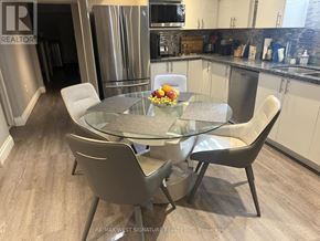 King (Nobleton) apartment for rent - A glass dining table with four chairs in a modern kitchen.