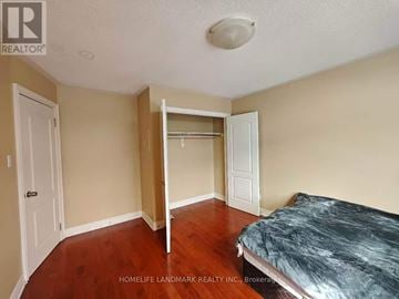 Markham (Wismer) apartment for rent - A bedroom with a bed, dresser, and mirror.