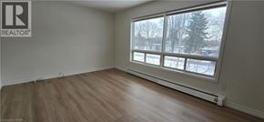 Kitchener apartment for rent - A room with a window showing a snowy landscape outside.