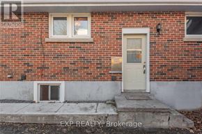 Orillia duplex for rent - A red brick house with a white door and windows.