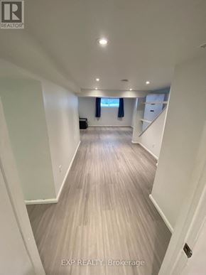 Orillia duplex for rent - A long hallway with wood flooring and white walls.