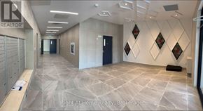 Brantford condo for rent - A hallway with a tiled floor and a wall with diamond-shaped decorations.