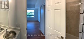 Brantford condo for rent - A bathroom with a sink and a door leading to another room.
