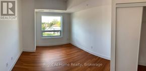 Brantford condo for rent - A room with a window and wooden floors.