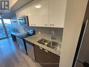 Waterloo condo for rent - A wooden wall with a silver elevator next to it.