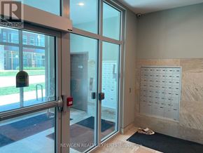Waterloo condo for rent - A balcony with a view of a multi-story building and a parking lot.
